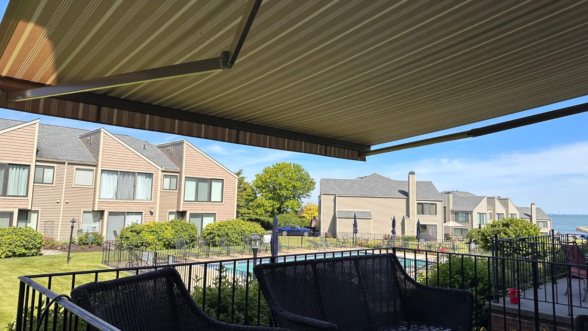 Motorized retractable awning over a backyard deck