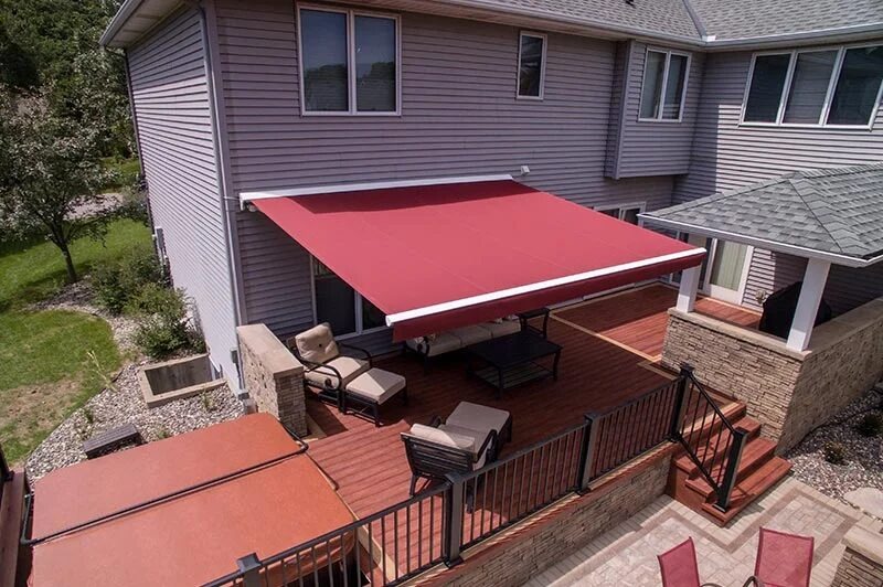 Cherry wood deck shaded by a red retractable awning.