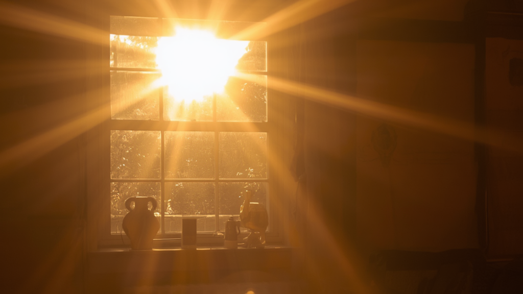 Intense summer sunlight beaming through a kitchen window.